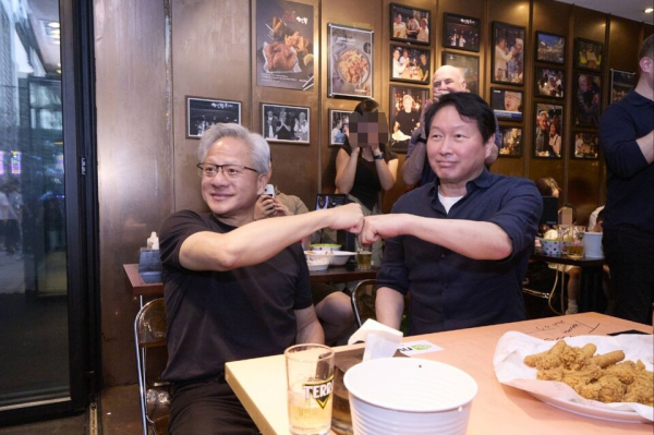 SK Group Chairman Chey Tae-won (right) and Nvidia CEO Jensen Huang reaffirm their partnership at a restaurant in Gangnam, Seoul, in June/ Courtesy of SK Group.